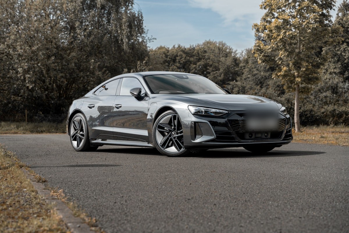 Grey electric grand tourer on a country road